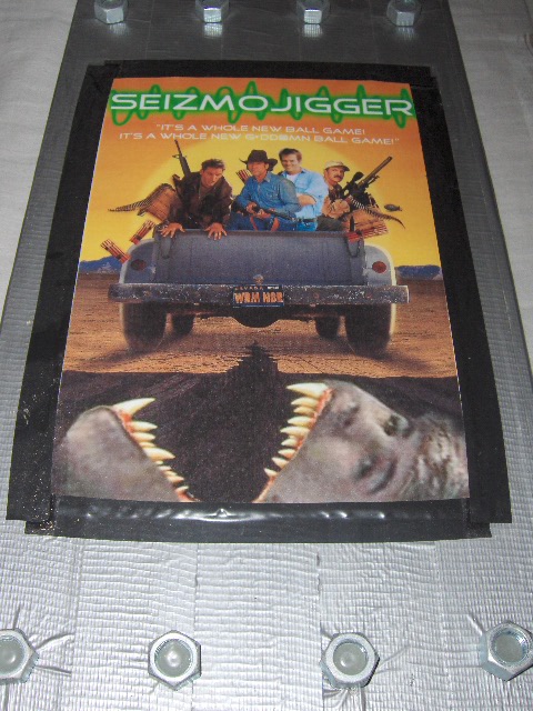 The customized Seizmojigger game box with duct tape and bolts